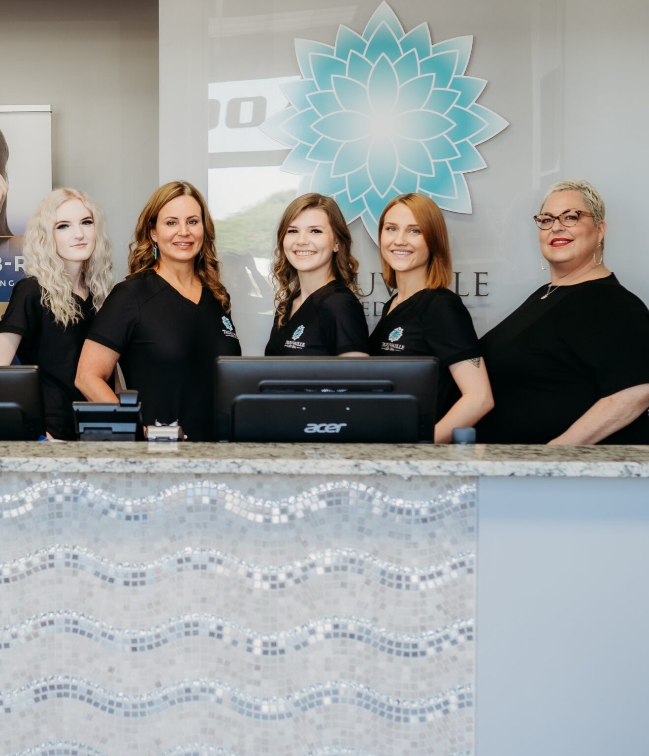 Staff standing at the front desk of a medical spa in Wilmington, IL.